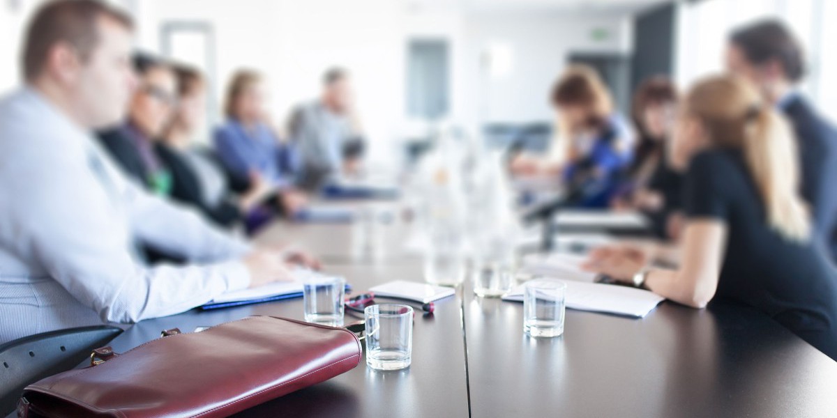 Business people facing each other along a table